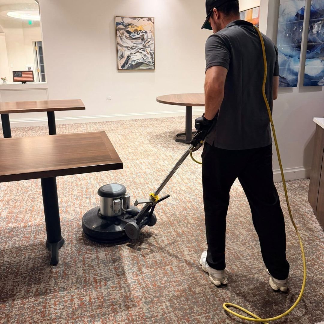 Technician cleaning commercial carpet in a Lake Mary, FL business