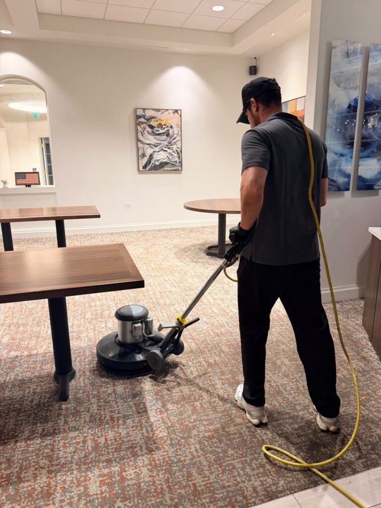 2M technician cleaning commercial carpet with a rotary floor machine in Lake Mary, FL